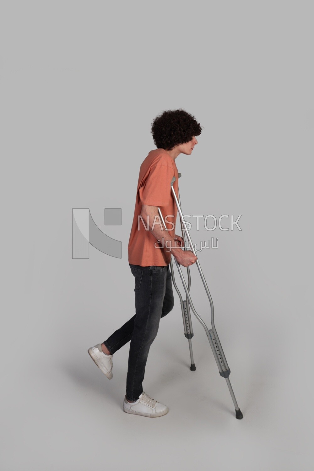 teenager rests on crutches