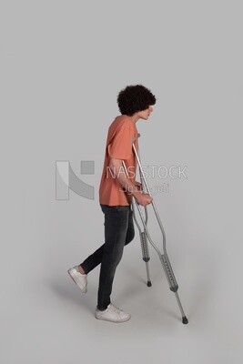 teenager rests on crutches