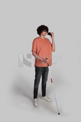 teenager with curly hair busy browsing his phone