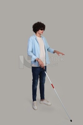 blind young man holding a walking stick