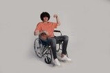 young man with a disability sits in a wheelchair