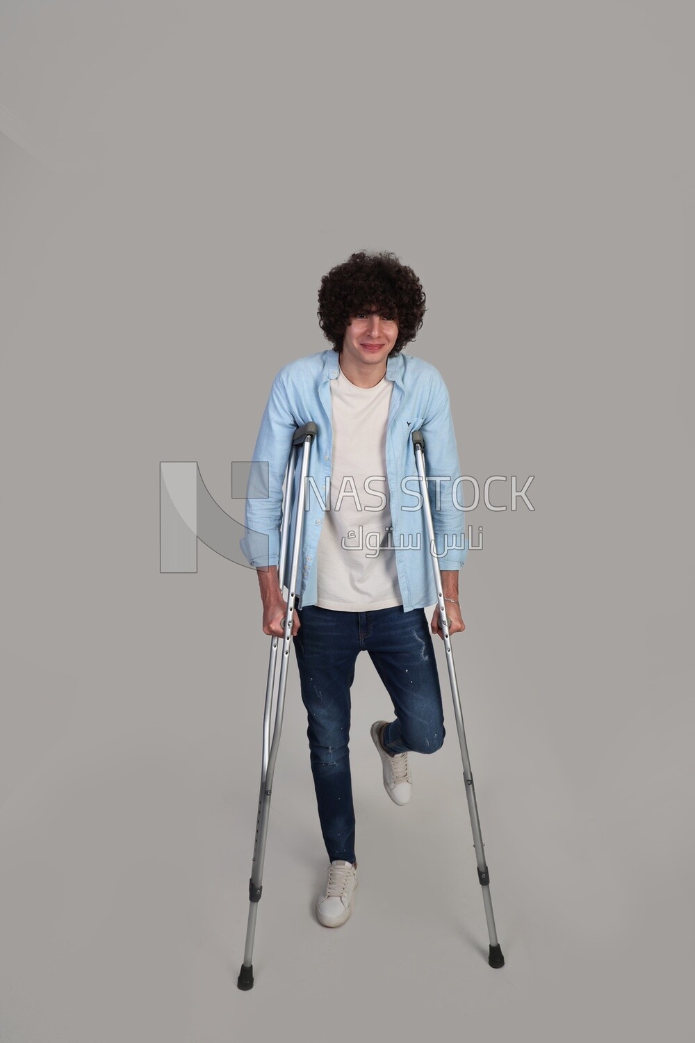 young man leaning on crutches