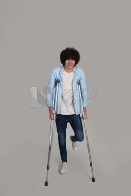 young man leaning on crutches