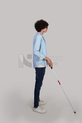 blind young man walking with a walking stick