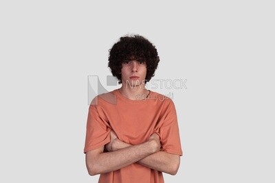 young man brings his hand to his chest