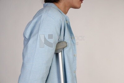 man leaning on crutches