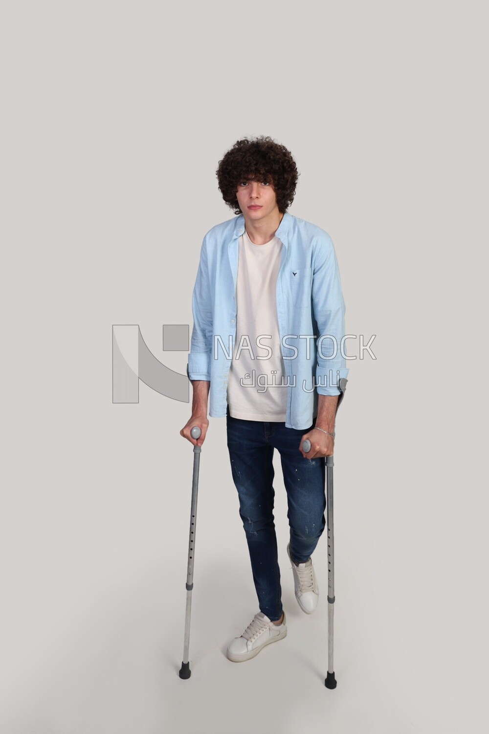 young man leaning on a crutch