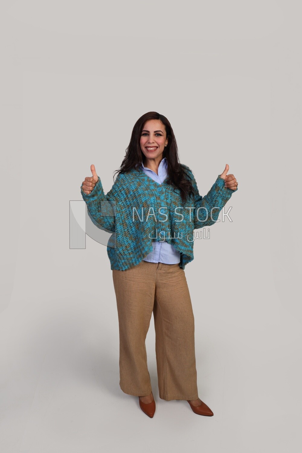 Beautiful girl raises her thumbs up