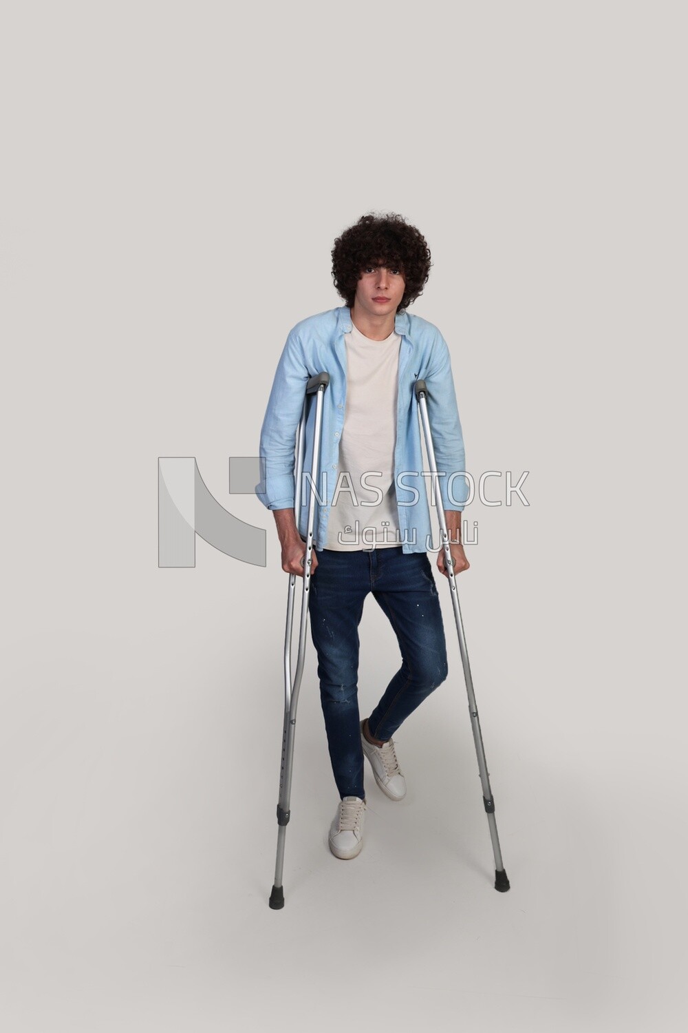 teenager is injured and rests on crutches