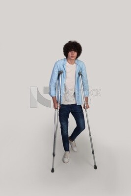 teenager is injured and rests on crutches