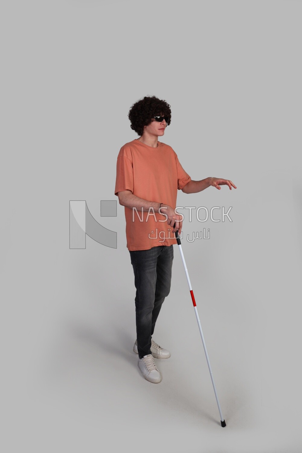 Blind teenager using a walking stick