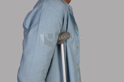 upper half of a man leaning on crutches