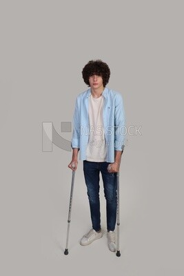 young man walking with crutches