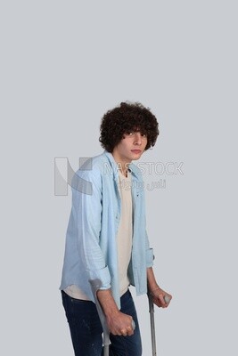young man leaning on crutches