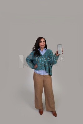 woman in winter showing phone screen