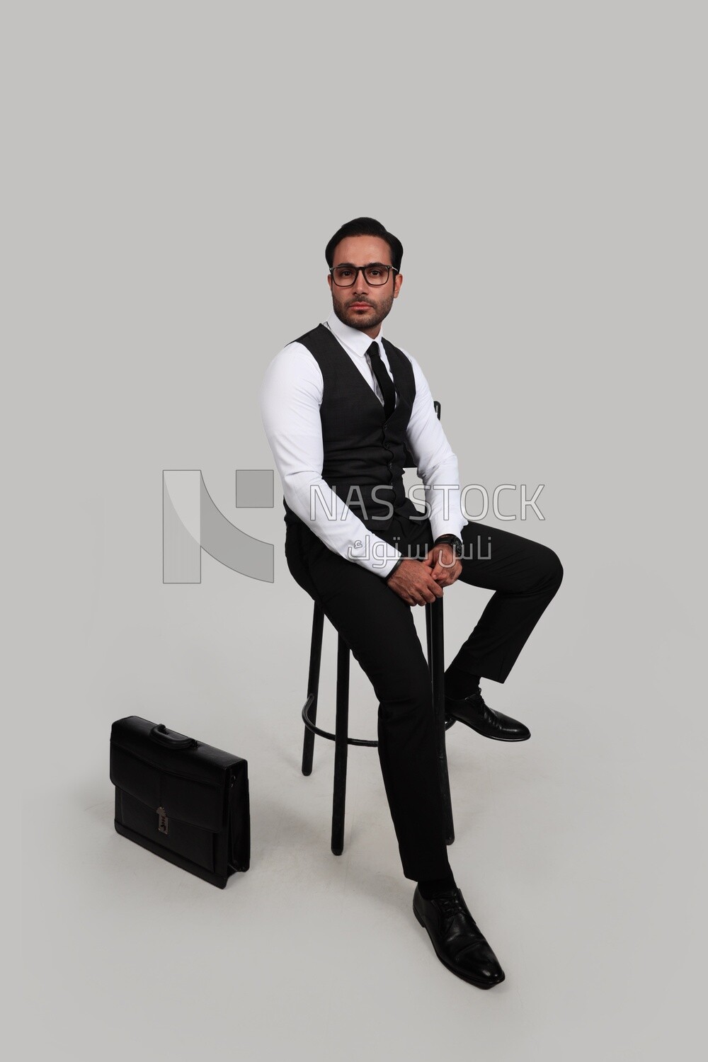 Photo of a businessman with a formal suit sitting on a chair, business development and partnerships, business meeting, Model