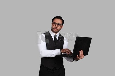 Businessman with a formal suit holding a laptop