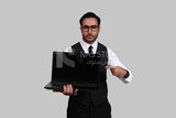 Photo of a businessman with a formal suit holding a laptop, business development and partnerships, business meeting, Model