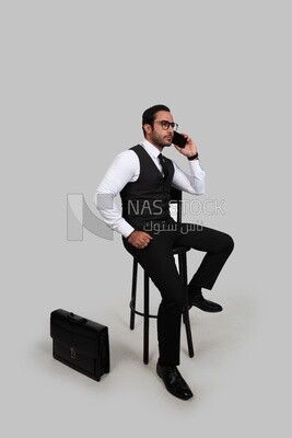 Photo of a businessman with a formal suit talking in his mobile phone, business development and partnerships, business meeting, Model