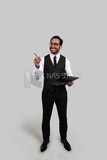 Photo of a businessman with a formal suit holding documents in one hand and a pen in the other, business development and partnerships, business meeting, Model