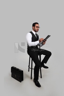 Photo of a businessman with a formal suit holding documents in one hand and a pen in the other, business development and partnerships, business meeting, Model