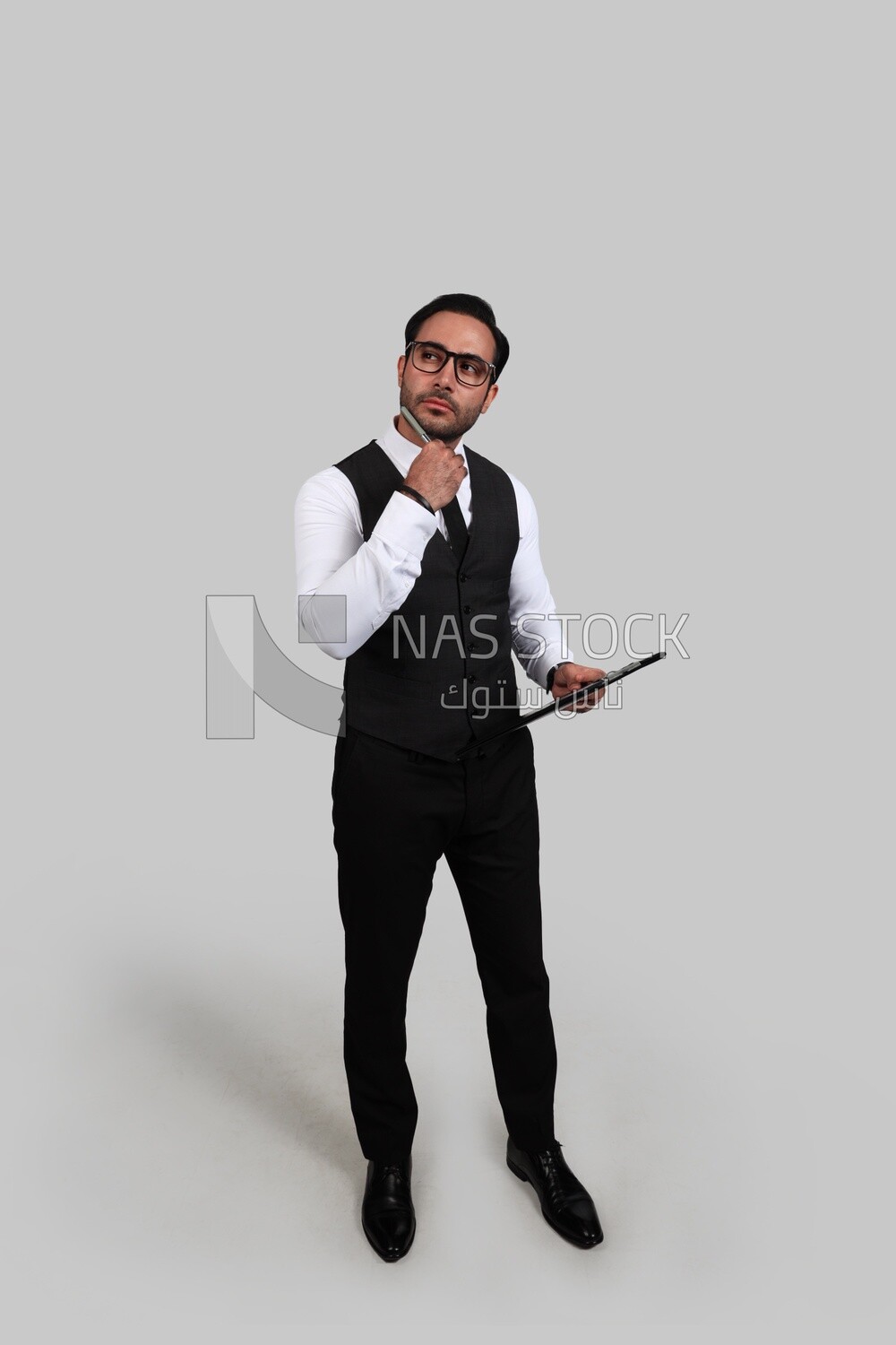 Photo of a businessman with a formal suit holding documents in one hand and a pen in the other, business development and partnerships, business meeting, Model