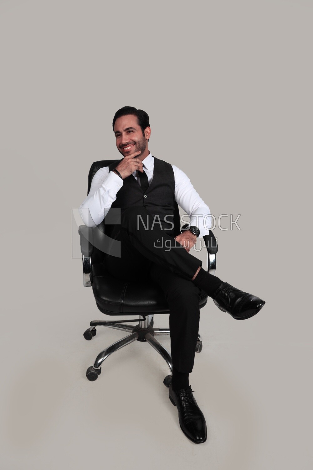 Photo of a businessman with a formal suit sitting on a chair putting a leg on a leg, business development and partnerships, business meeting, Model