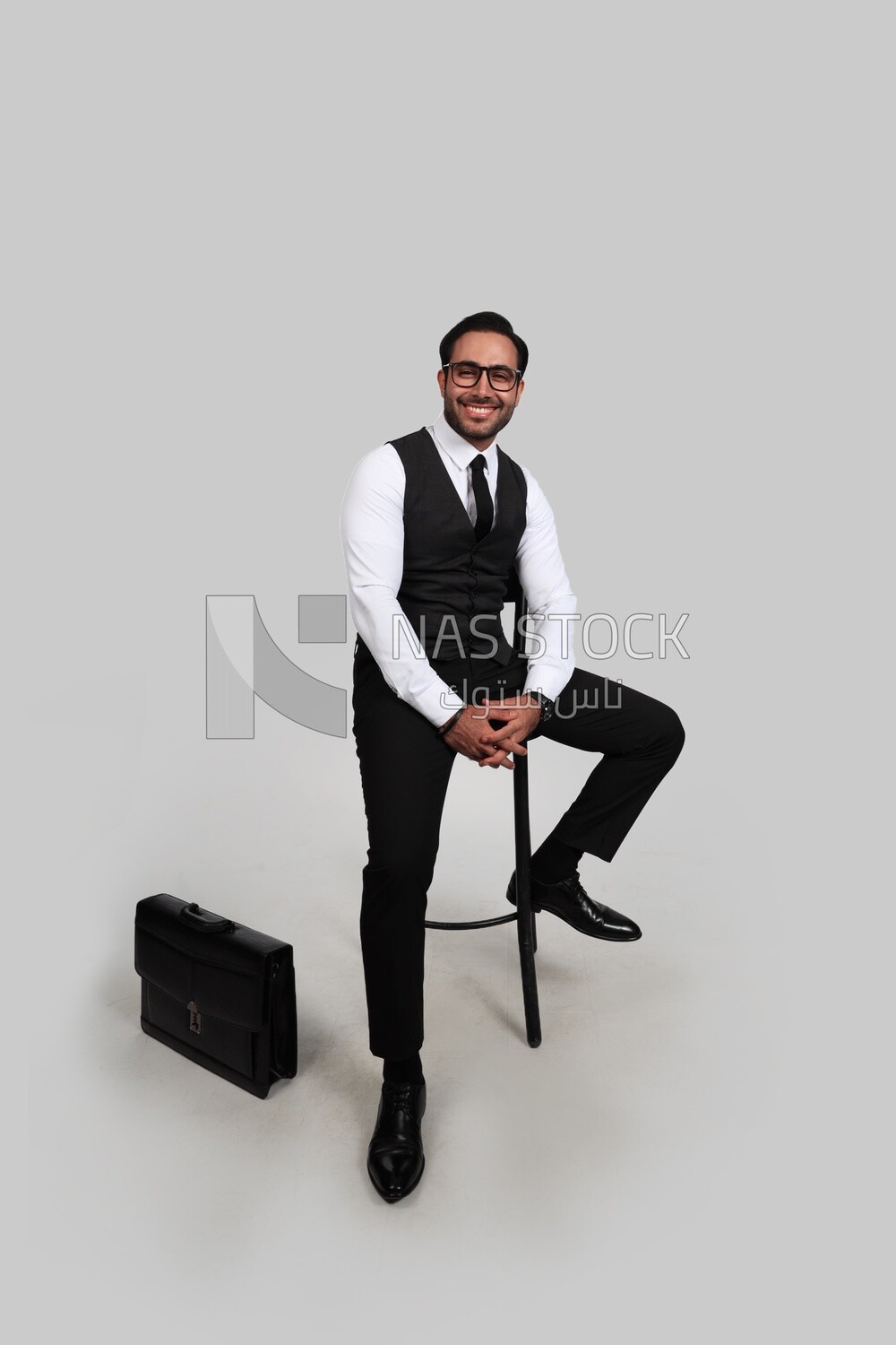 Photo of a businessman with a formal suit sitting on a chair, business development and partnerships, business meeting, Model