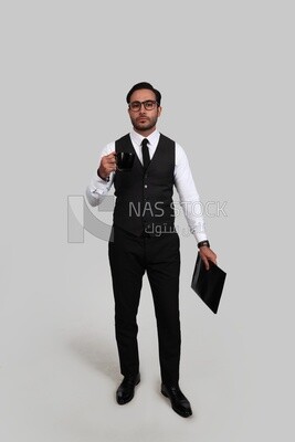 Photo of a businessman with a formal suit holding documents in one hand and a cup in the other, business development and partnerships, business meeting, Model