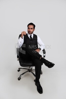 Photo of a businessman with a formal suit sitting on a chair putting a leg on a leg, business development and partnerships, business meeting, Model