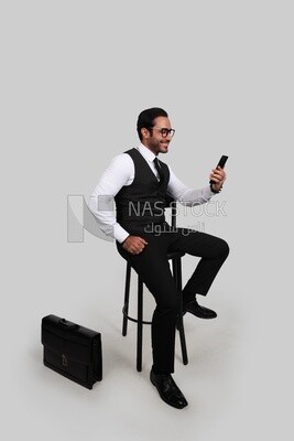 Photo of a businessman with a formal suit checking his mobile phone, business development and partnerships, business meeting, Model