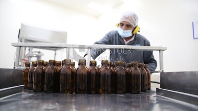 Worker sorts bottles before filling medicines into them