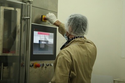 Factory worker operating a machine