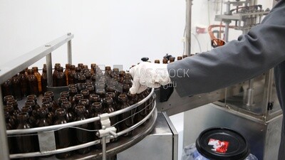 Stacked bottles in a machine, industries, medical medicine industry, packaging