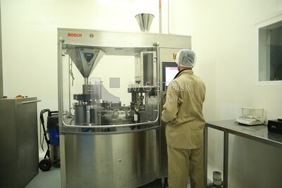 Factory worker operating a machine