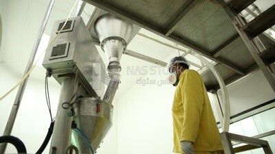 Factory worker operating a machine