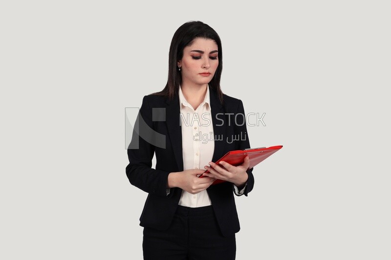 Photo of a businesswoman with a formal suit standing and holding documents, business development and partnerships, business meeting, Model