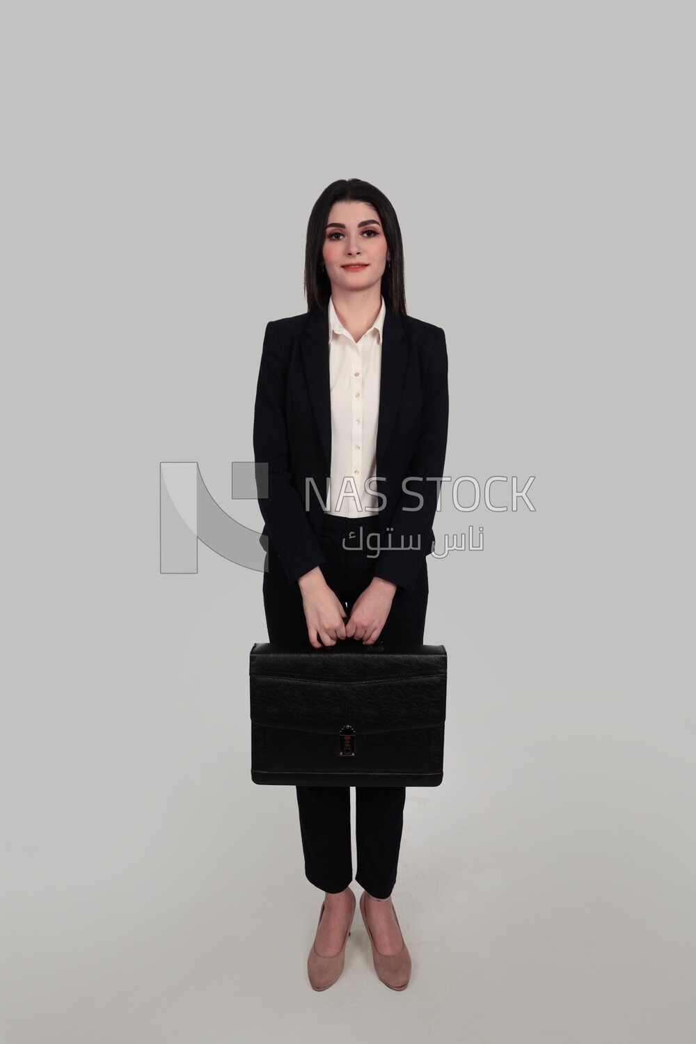 Photo of a businesswoman with formal wear standing and holding a leather bag, business development and partnerships, business meeting, Model
