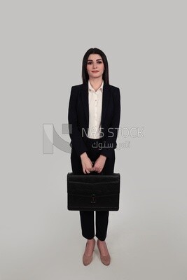 Photo of a businesswoman with formal wear standing and holding a leather bag, business development and partnerships, business meeting, Model