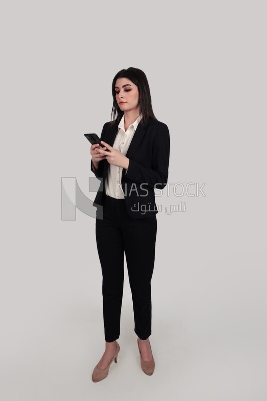 Photo of a businesswoman with formal wear holding a mobile phone, business development and partnerships, business meeting, Model