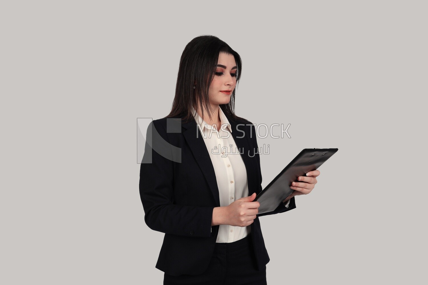 Photo of a businesswoman with a formal suit standing and holding documents, business development and partnerships, business meeting, Model