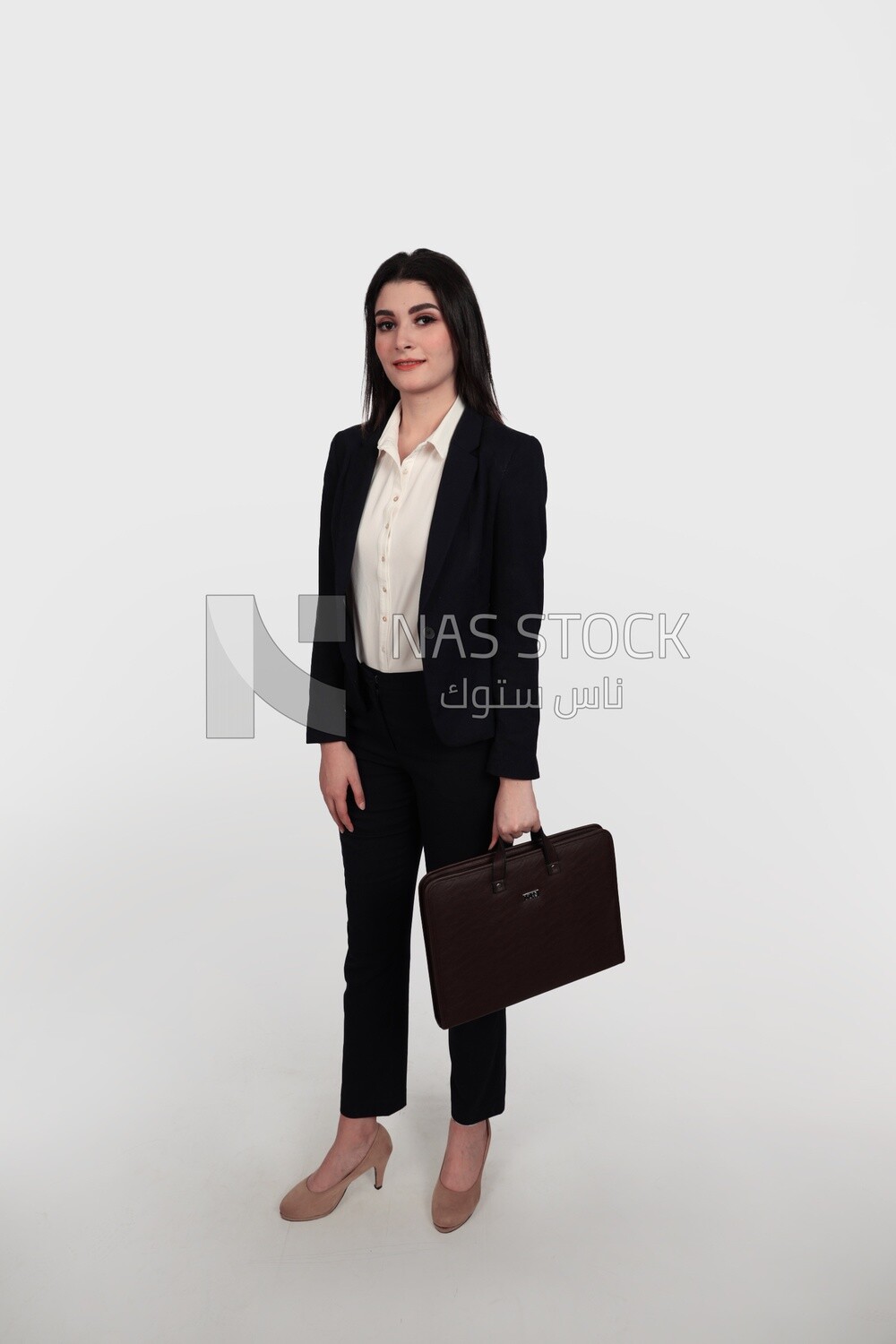 Photo of a businesswoman with formal wear standing and holding a leather bag, business development and partnerships, business meeting, Model