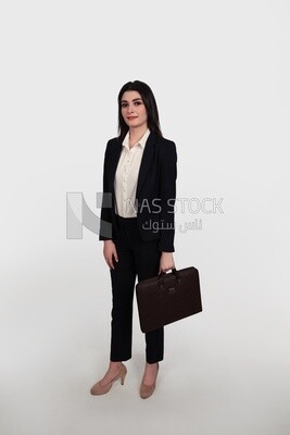 Photo of a businesswoman with formal wear standing and holding a leather bag, business development and partnerships, business meeting, Model