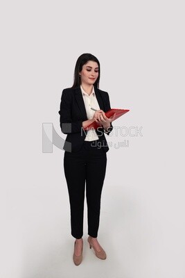 Businesswoman with a formal suit standing and holding documents
