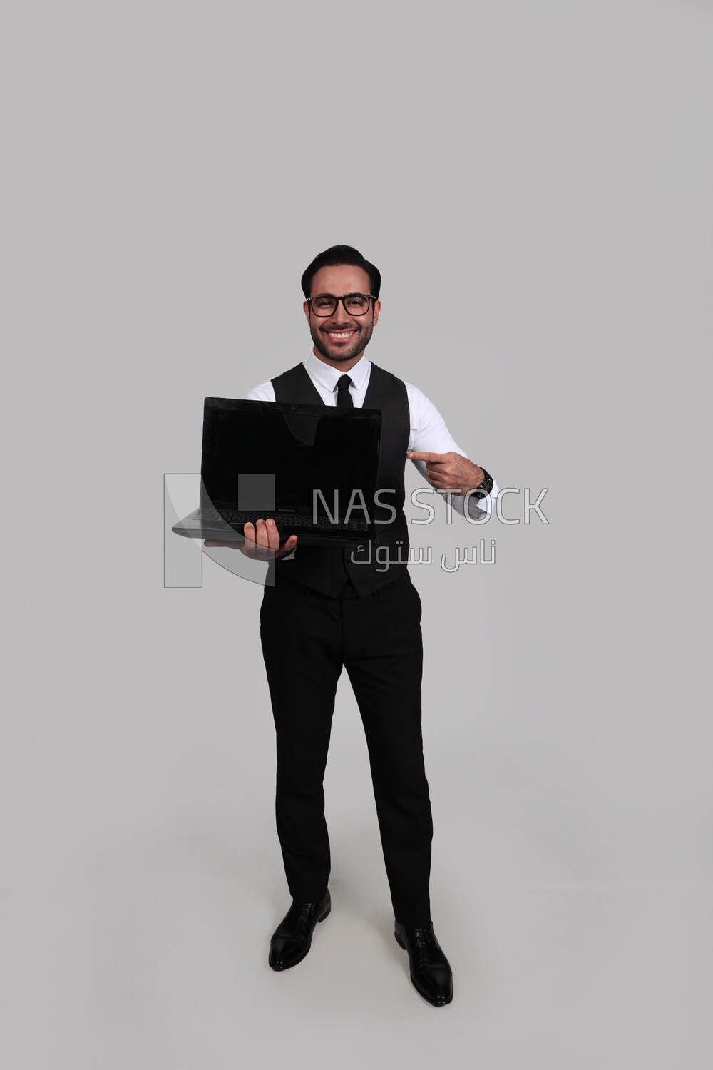 Businessman with a formal suit holding a laptop