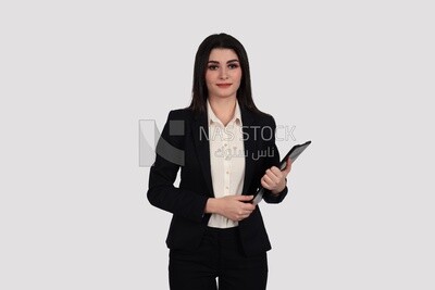 Photo of a businesswoman with a formal suit standing and holding documents, business development and partnerships, business meeting, Model