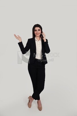 Photo of a businesswoman with formal wear standing on a white background and talking on the phone, business development and partnerships, business meeting, Model