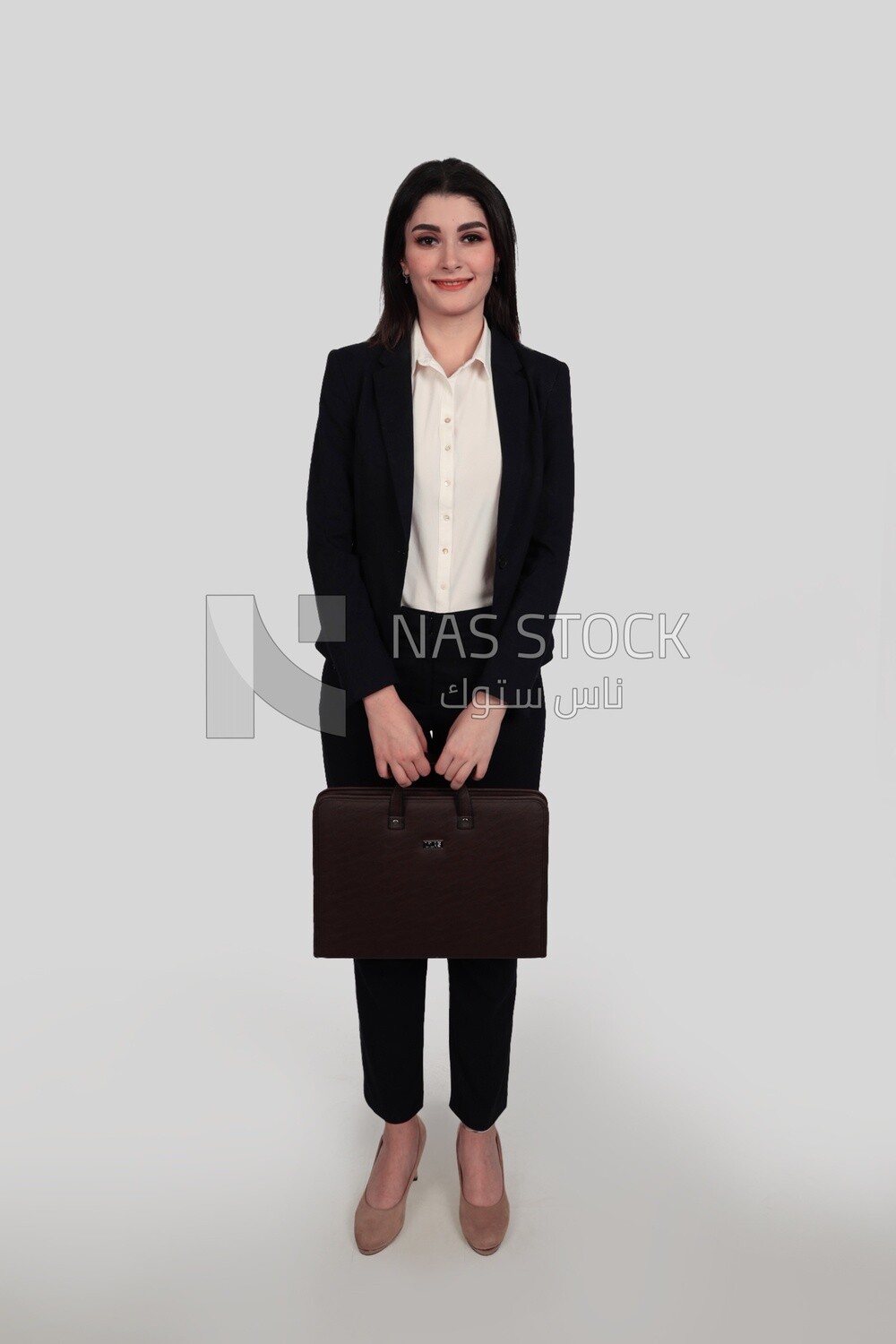 Photo of a businesswoman with formal wear standing and holding a leather bag, business development and partnerships, business meeting, Model