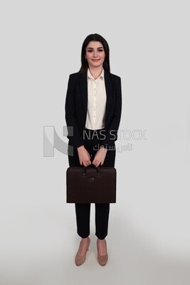 Photo of a businesswoman with formal wear standing and holding a leather bag, business development and partnerships, business meeting, Model