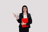 Photo of a businesswoman with a formal suit standing and holding documents, business development and partnerships, business meeting, Model